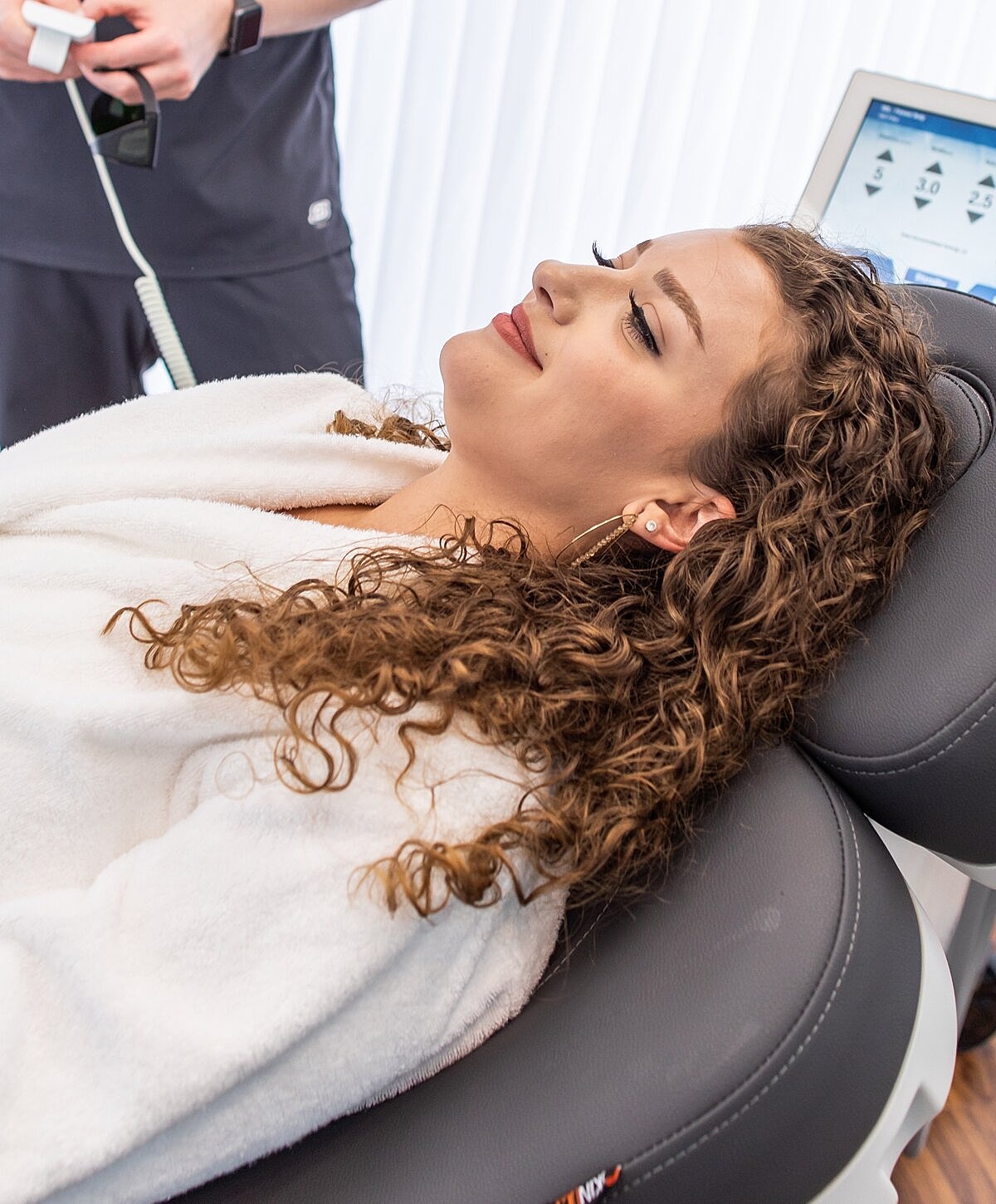 Woman relaxing by a pool, serene expression.