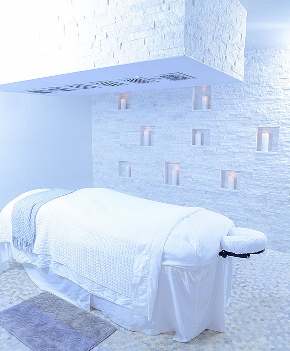 Woman walking on beach at sunset, flowing dress.