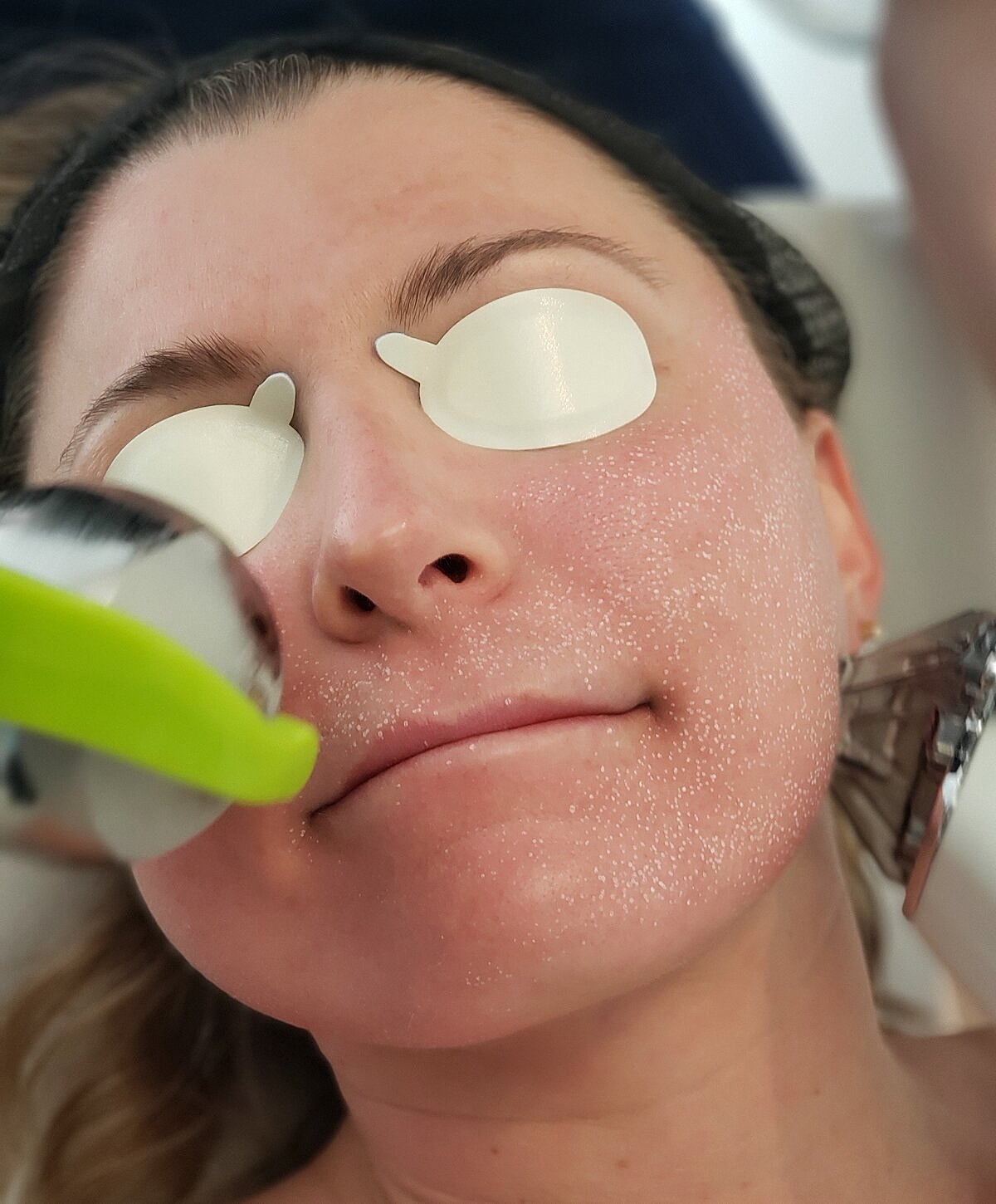 Woman relaxing by a pool, serene expression.