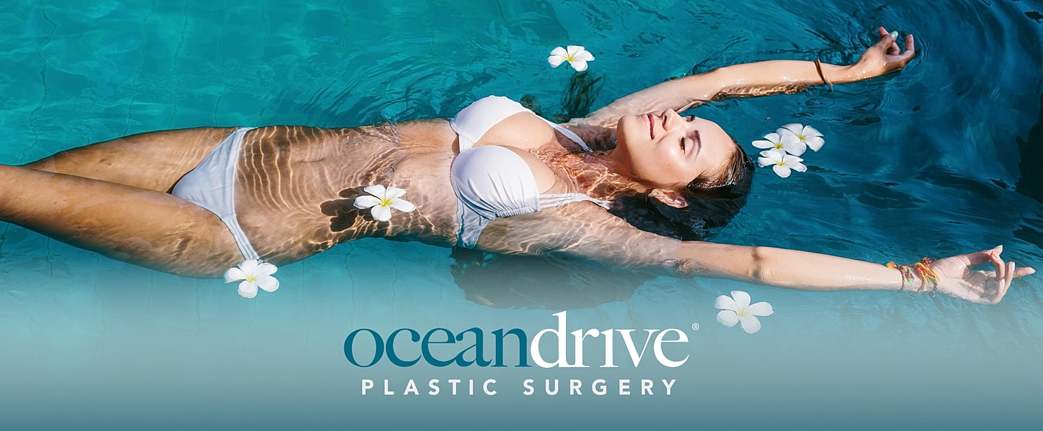 Woman relaxing in water with flowers.