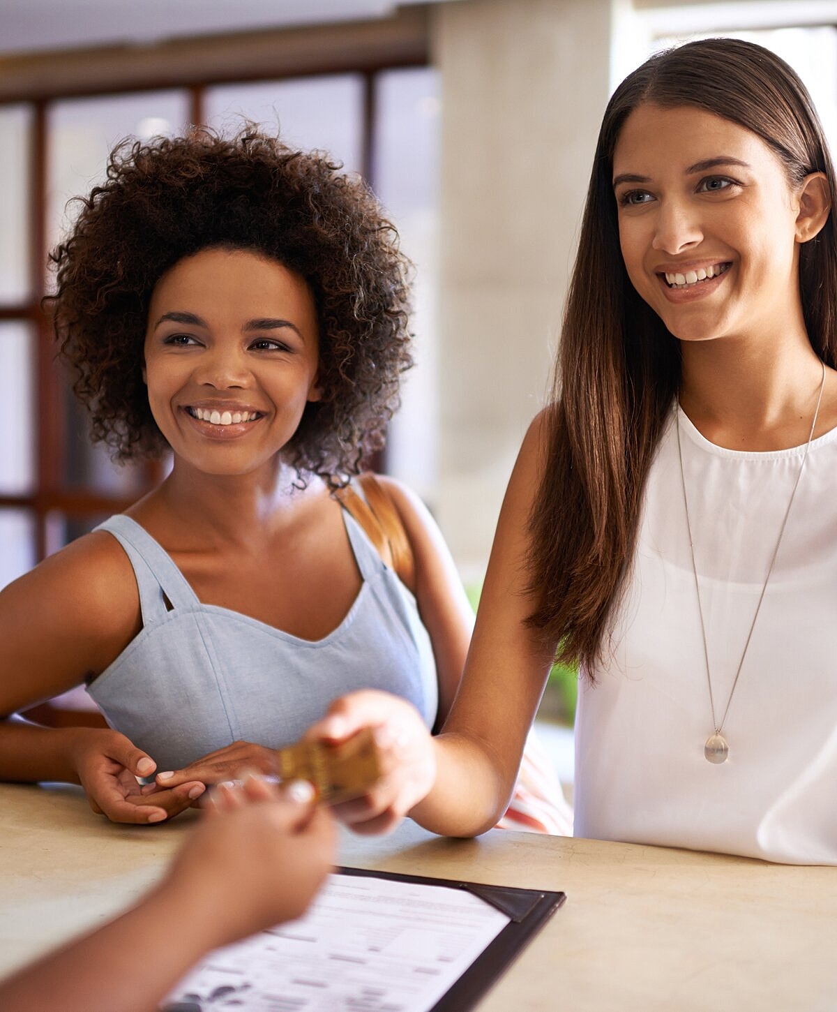 Woman with wet hair sitting on the beach.