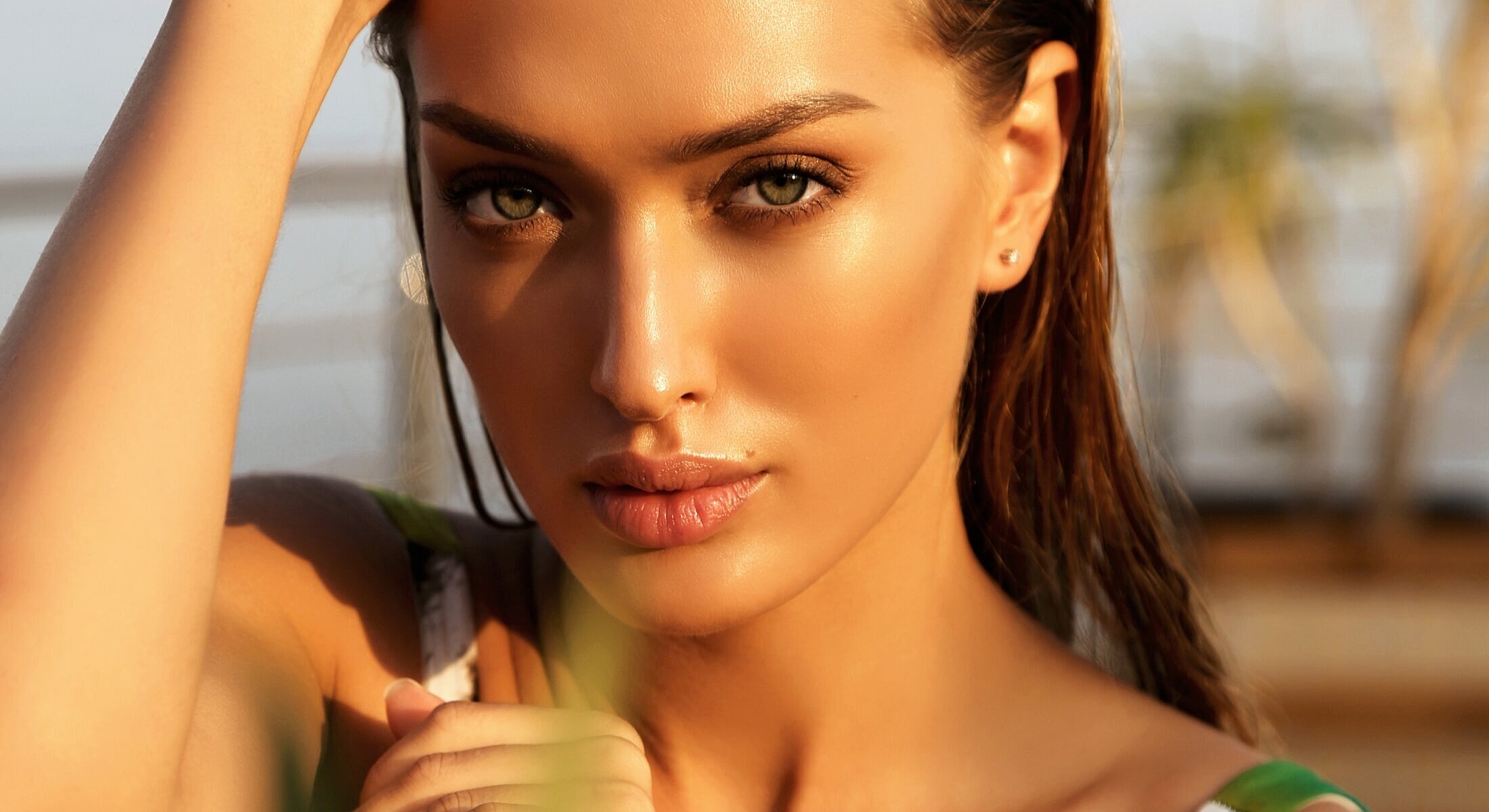 Close-up of a woman with glowing skin.