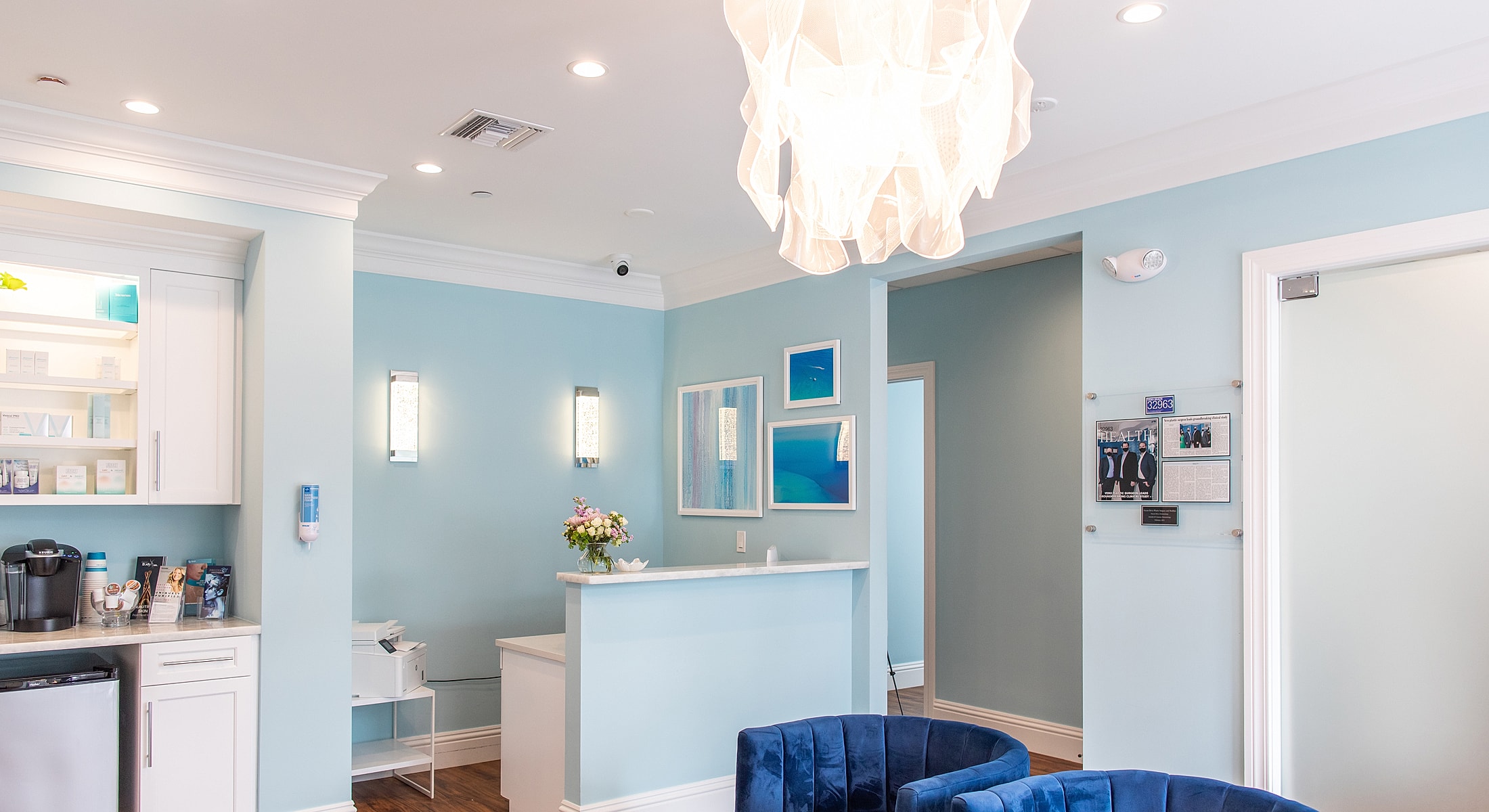Modern reception area with blue decor and plants.