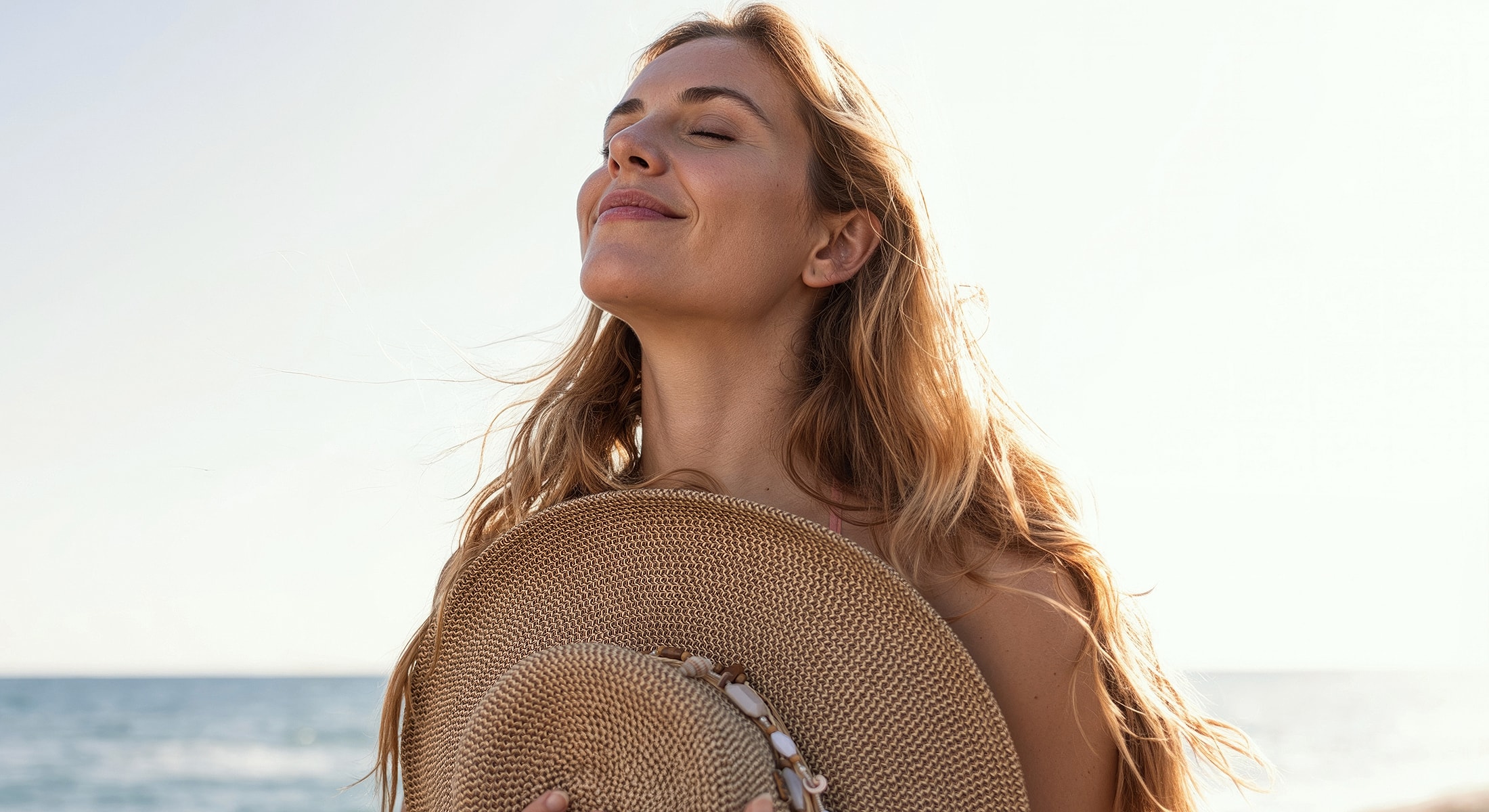 Smiling woman enjoying the seaside sunshine.