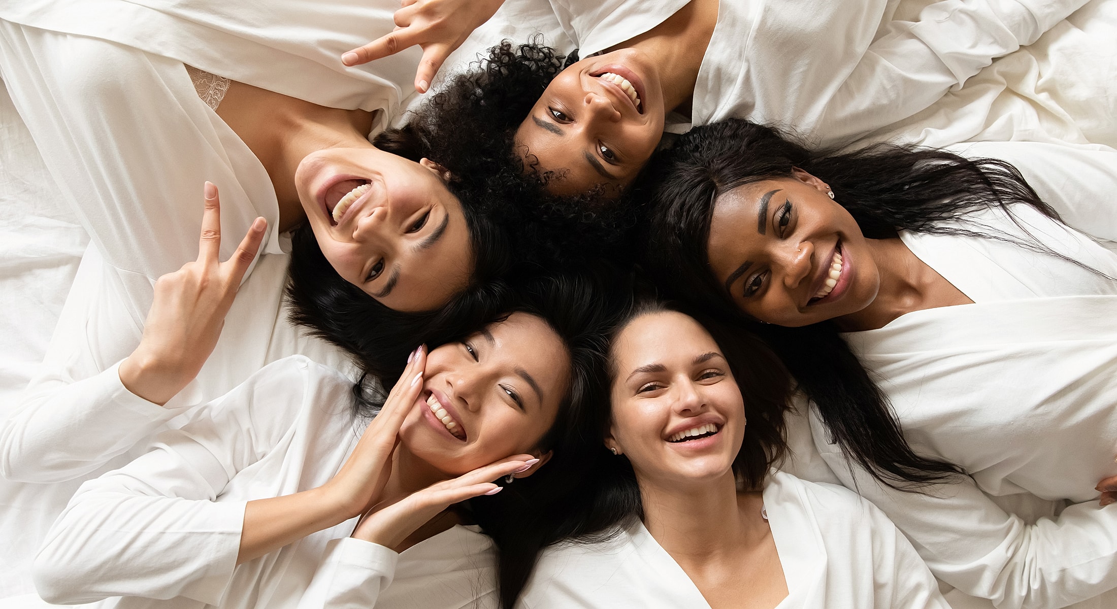 Friends smiling together in shared joy.